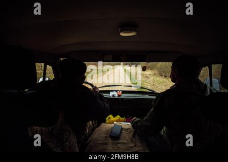the driver is driving off-road. view from the interior of a four-wheel-drive car on a dirt road. dangerous passage of the trophy raid. extreme driving Stock Photo
