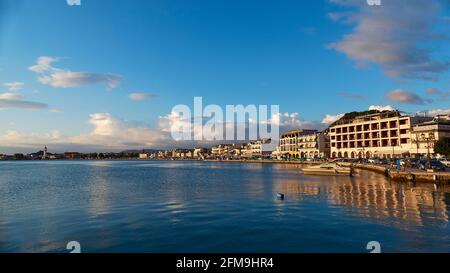 Zakynthos, Zakynthos town, view of the town from the port, dark blue sky, gray and white clouds, morning light, dark blue sea, lower half of the sea, upper half of the sky, wide angle shot, promenade of Zakynthos old town Stock Photo