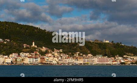 Zakynthos, Zakynthos city, view of the city from the port, sky dark blue, clouds gray and white, morning light, sea dark blue, lower quarter sea, fortress hill, chapel, old town Stock Photo