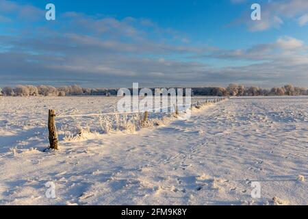 Sunrise in Wiesmoor, Eastfrisa on a cold winter morning with snow and a colorful sunrise. Stock Photo