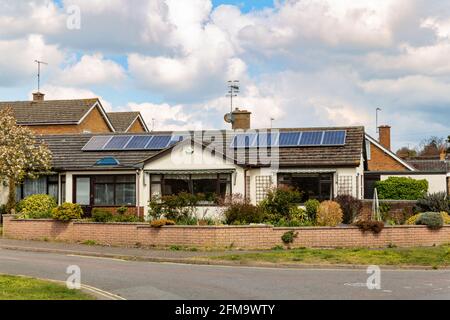 Woodbridge, Suffolk, UK April 30 2021: A small traditional bungalow with solar panels on the roof. Green energy solar energy Stock Photo