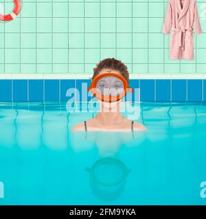 Woman in indoor swimming pool with diving goggles (M) Stock Photo