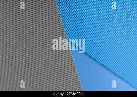 Blue and gray corrugated paper texture. Geometric shapes and lines. Minimalist background. Flat lay. Copy space. Stock Photo