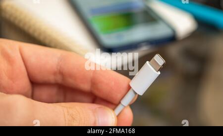 Kharkov, Ukraine - April 27, 2021: Lightning connector close-up in hand Stock Photo