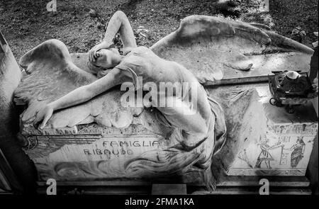 GENOA, ITALY - June 2020: antique statue of angel (1910, marble) in a Christian Catholic cemetery - Italy Stock Photo