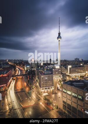 View of the Berlin TV tower and the illuminated streets on Alexanderplatz at night. Stock Photo