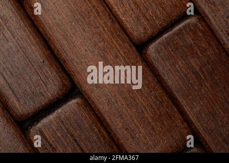 Dark wood texture in the shape of small rectangles (collection of natural and vegetal fibers). Foreground. Stock Photo