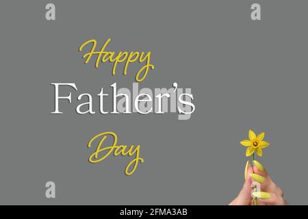 Fathers Day card with female hand holding daffodil flower Stock Photo