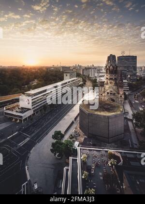 Sunrise behind the Memorial Church on Breitscheidplatz in Berlin with a view of the Bikini shopping center. Stock Photo