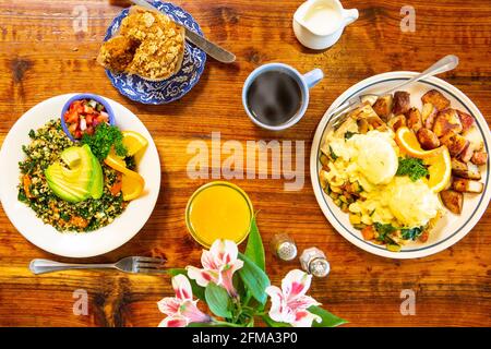 vegetarian eggs Benedict and a vegan scramble are enjoyed by two freiends Stock Photo