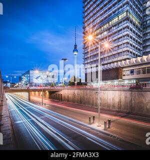Traces of light from the night traffic in Berlin in front of the television tower and Alexanderplatz. Stock Photo