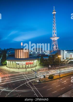 Road traffic in front of the illuminated Berlin radio tower on the exhibition grounds at dusk. Stock Photo