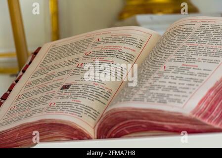 Sierpc, Poland - May 6, 2021: Missal in Latin on the altar in the old chapel. Old open book. Old liturgical accessories. Stock Photo