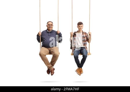 Father and teenage student son sitting on wooden swings isolated on white background Stock Photo