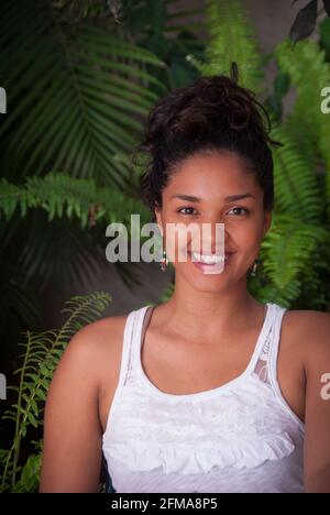Portrait of smiling young Hispanic woman - Casa Amorita B&B, Puerto Vallarta on the Pacific Ocean's Bahia de Banderas, Jalisco, Mexico. #613PV Stock Photo