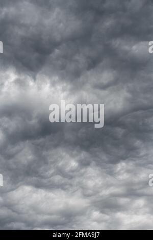 Moody sky with clouds forming  shapes.  A gray overcast day is enlightened by soft shapes in the cloud deck Stock Photo