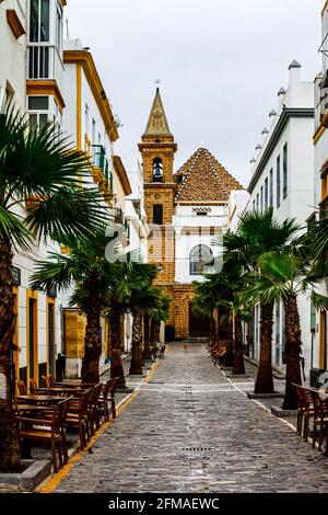 Street Virgen de la Palma with Church Nuestra Senora de la Palma. Cadiz, Andalusia, Spain. Stock Photo