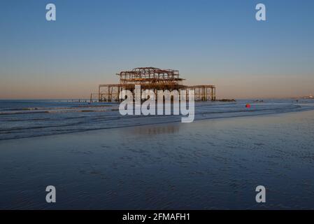 The solitary rusting remains of the West Pier at low tide. Brighton & Hove, Sussex, England, UK Stock Photo