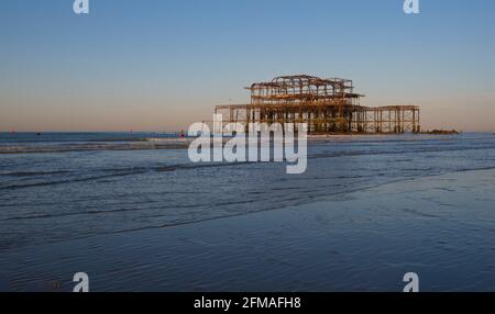 The solitary rusting remains of the West Pier at low tide. Brighton & Hove, Sussex, England, UK Stock Photo