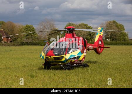 Windsor, UK. 7th May, 2021. The Thames Valley Air Ambulance helicopter is pictured stationary in a field alongside Windsor Great Park. Thames Valley Air Ambulance's Airbus H135, with a maximum speed of 160mph, is able to reach any destination in Berkshire, Buckinghamshire or Oxfordshire within fifteen minutes. Credit: Mark Kerrison/Alamy Live News Stock Photo