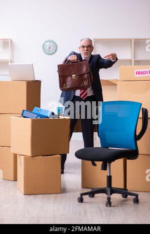 Old male employee in relocation concept Stock Photo