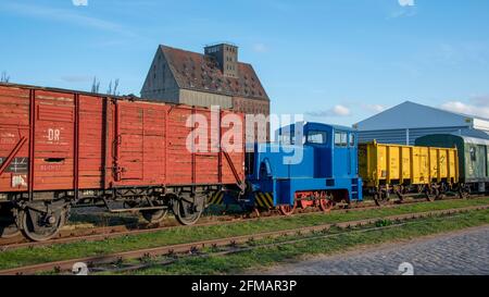 Germany, Saxony-Anhalt, Magdeburg, blue diesel locomotive, wooden railway wagons. Stock Photo