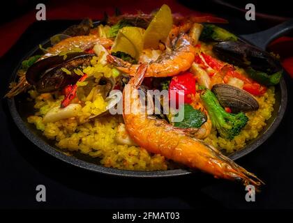 A hot skillet with a delicious plate of paella ready to eat in Enoshima, Japan (iPhone 12 Mini). Stock Photo