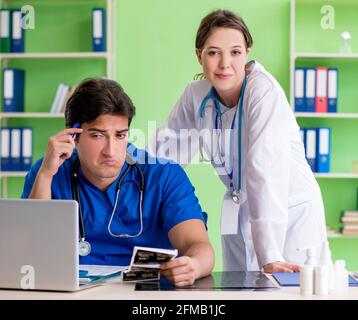 Woman and man gynecologists discussing medical case at the clinic Stock Photo