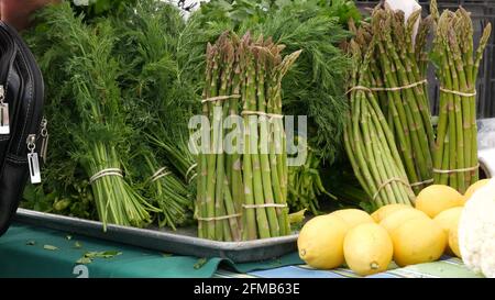 Organic vegetables on counter, fresh local produce homegrown raw veggies on marketplace stall. Healthy vegetarian food, Farmers market in Oceanside California USA. Agricultural farm harvest selling. Stock Photo
