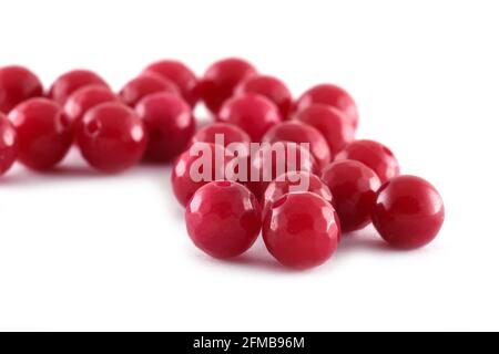 Red Beads spread on white background. Background or texture of beads.Close up,used in finishing fashion clothes. make bead necklace or string of beads Stock Photo