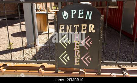 Open Enter Here Sign at a Small Business Stock Photo