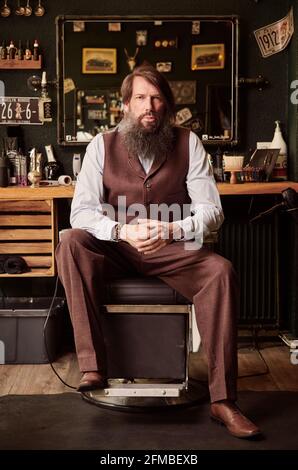 Bearded middle aged man in barber shop Stock Photo