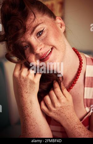 Young woman with Down Syndrome in a retro look in an ice cream parlor Stock Photo