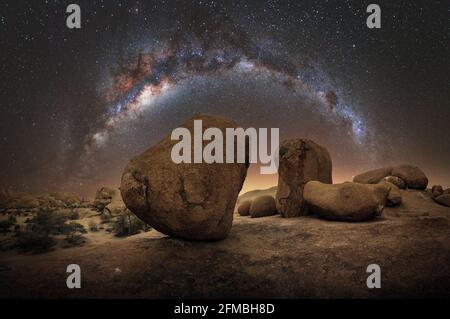 Night shot with Milky Way over abstract rocks in Namibia. Stock Photo