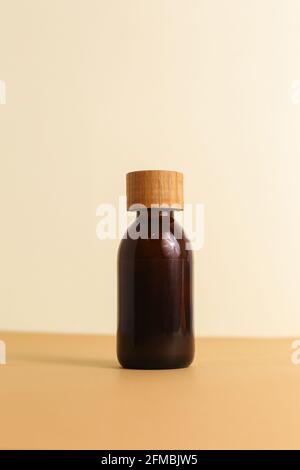 Man's cosmetics for hair in the glass bottle on neutral background Stock Photo