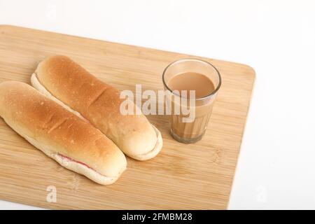 Famous breakfast. Tea and Bun on wooden background Stock Photo