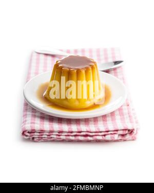 Sweet vanilla pudding. Sweet dessert with caramel topping isolated on white background. Stock Photo