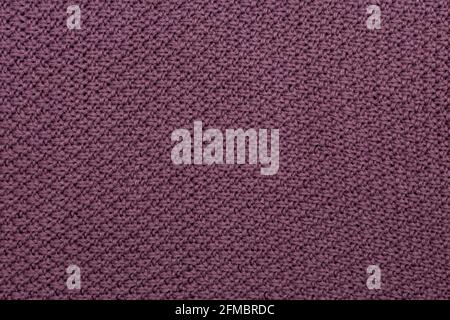Knitted fabric pearl woolen background. The structure of the fabric with a natural texture. Fabric background. Knitted woolen background. Stock Photo