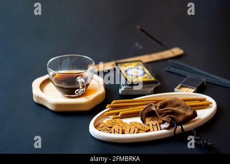 Modern, minimal still life with runes and tarot cards on table. Magic  ritual, esoteric and occult background with copy space. Reading future concept. Stock Photo
