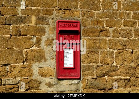 A post box in a Cotswold stone wall, Barford St. John, Oxfordshire, UK Stock Photo