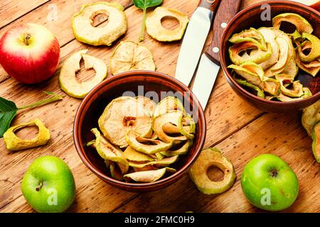 Apple chips on rustic wooden background.Dried apples Stock Photo