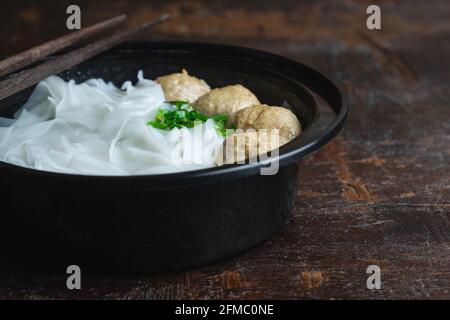 Noodles with meatballs on a wooden table Stock Photo