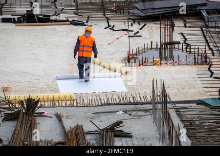 Insulation worker and process of hydro insulation at construction site. Stock Photo