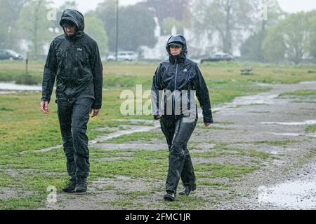London, UK. 08 May 2021.  Walkers brave the wet conditions and heavy rain drizzle in the morning on Wimbledon Common. The forecast is for unsettled weather and rain during the  weekend before temperatures improve. Credit amer ghazzal/Alamy Live News Stock Photo
