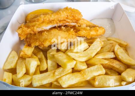 Fresh Scottish haddock deep fried in light, crispy batter. Stock Photo