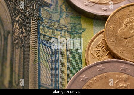 Series of macro shots of euro coins. Close up of 100 euro bill with some coins on it as a background Stock Photo