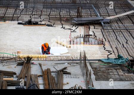 Professional insulation worker and process of hydro insulation at construction site. Stock Photo