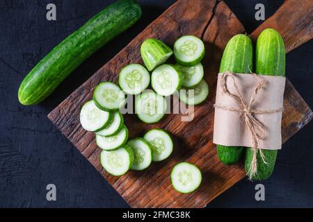 Fresh cucumber on a wooden cutting board Stock Photo