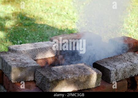 Smoke coming out of grill in backyard Stock Photo - Alamy