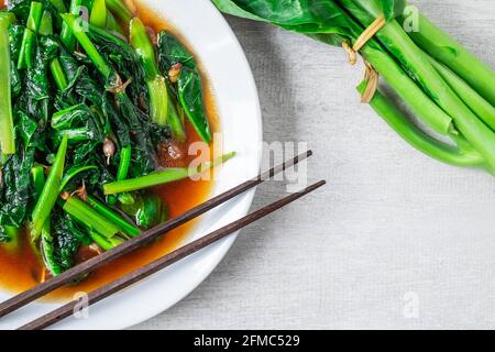Fried Kale with Oyster Sauce menu on wooden table Stock Photo